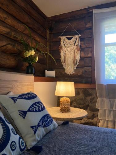 a bedroom with a bed and a table with a lamp at Vējavas in Svettsiyems