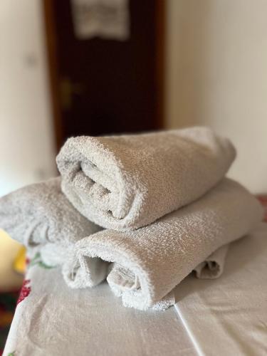 a pile of towels sitting on top of a bed at Kapija Lukomira in Konjic