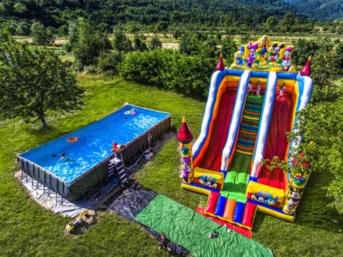 an aerial view of two inflatable slides and a pool at Transalpina Retreat in Novaci