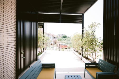 two benches in a building with a view of a street at Noemie Hotel in Himare