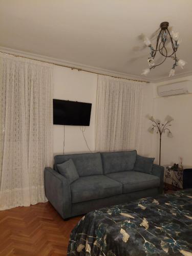 a living room with a couch and a flat screen tv at Luxury Apartman ZOGAN in Opatija