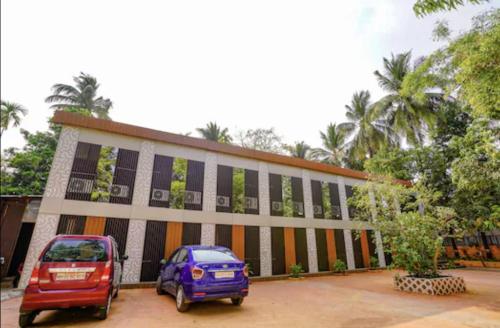 two cars parked in front of a building at HOTEL MOON LITE RESIDENCY - Marve Road Malad West in Mumbai