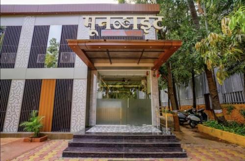 a entrance to a building with a wooden roof at HOTEL MOON LITE RESIDENCY - Marve Road Malad West in Mumbai