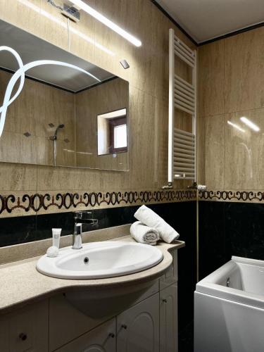 a bathroom with a sink and a mirror at Marsali Vila in Constanţa