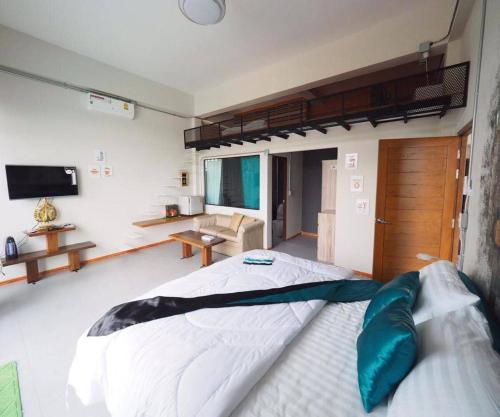 a bedroom with a large bed and a living room at Daiya Nirvana Pool Villa, Khao Yai in Klang Dong
