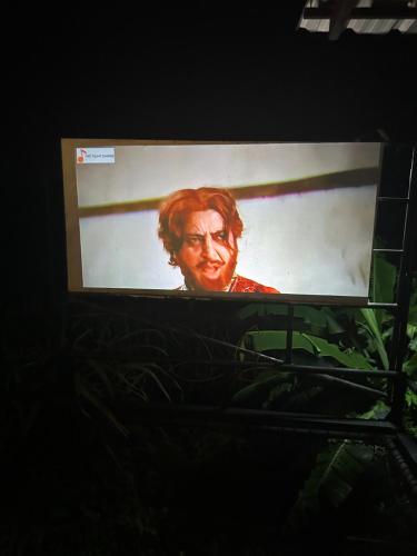 a television screen with a picture of a woman at Daiya Nirvana Pool Villa, Khao Yai in Klang Dong