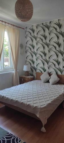 a bedroom with a large bed with a large wall at Casa Silvia - Corbu in Corbu