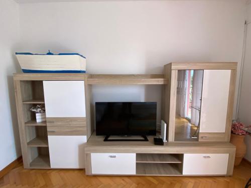 a wooden entertainment center with a flat screen tv at Portorož Apartments Franca in Portorož