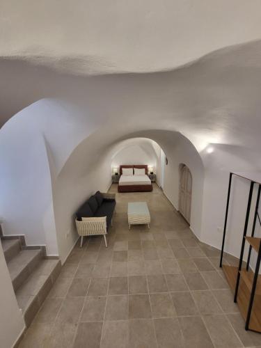 a living room with a couch and a bed at Cave Houses Mesaria in Mesaria