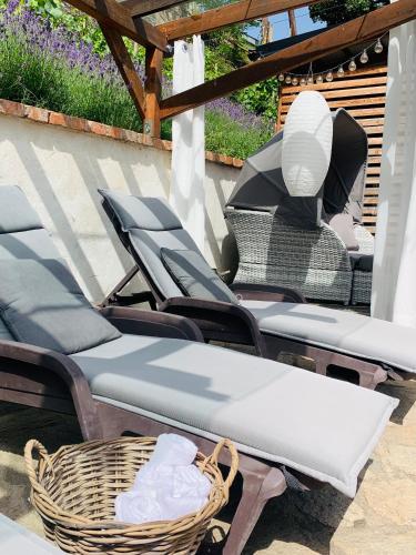 a group of chairs sitting on a patio at Boutique Apartments Felicino údolí in Vranov nad Dyjí