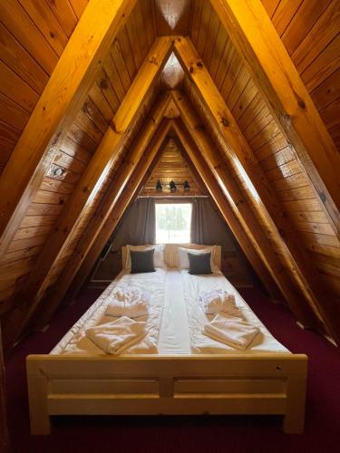 a bed in the attic of a wooden house at Chalet Musala Borovets by BookVillaBG in Borovets