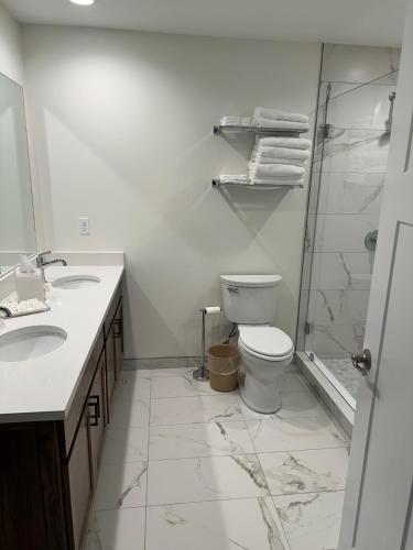 a white bathroom with a toilet and a shower at Lakeview Hills Golf & Resort in Lexington