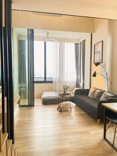 a living room with a couch and a table at 2BR BTS On Nut Siamese87 Two Bedroom LOFT hight floor 24 in Bangkok