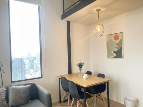 a dining room with a table and chairs at 2BR BTS On Nut Siamese87 Two Bedroom LOFT hight floor 24 in Bangkok