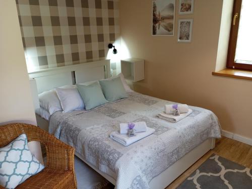 a bedroom with a bed with two towels on it at Przytulne Studio Borówkowy Zagajnik in Piechowice