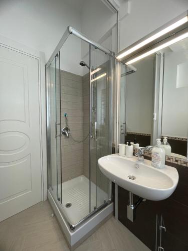 a bathroom with a glass shower and a sink at Pollina Suites & Apartments in Pollina