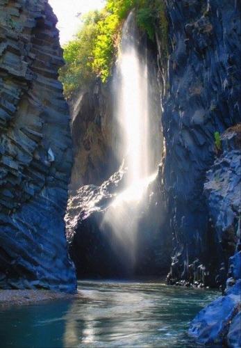 a waterfall in the middle of a river at Casa Belvedere Motta Camastra Gole Alcantara in Motta Camastra