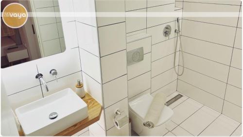 a white bathroom with a sink and a shower at Vaya Zorba Studios in Skiathos Town