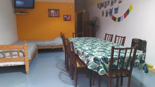 a room with a table and chairs and a bed at Cabañas en Koslay Ñalala Ivoqué con piscina climatizada en épocas cálidas in Juana Koslay 