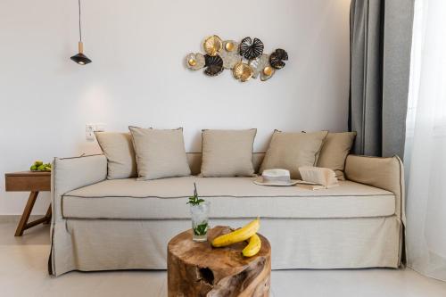 a living room with a couch and a table with bananas on it at Birikos Hotel & Suites in Agios Prokopios