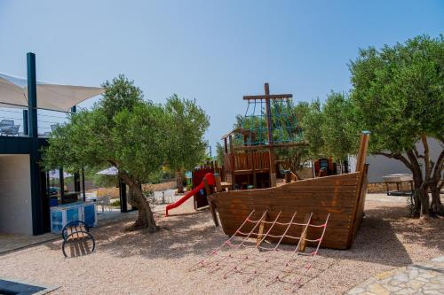 a playground with a slide at Mobile Homes Pirovac with 2 shared Pools in Pirovac