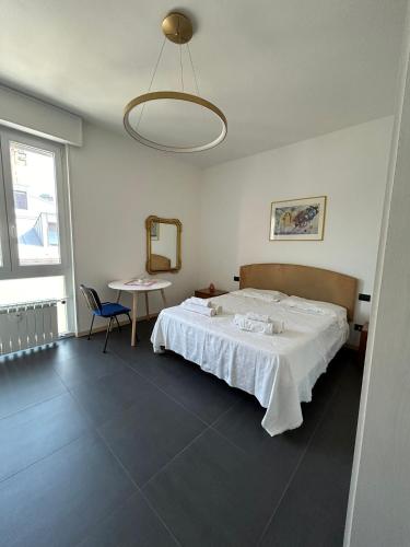 a bedroom with a bed and a table and a mirror at M&M BERGAMO CENTER - Modern flat with FREE WIFI - Rent BIKE in Bergamo