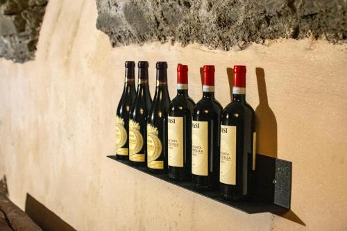 a row of wine bottles on a shelf on a wall at Vista B&B in Pella
