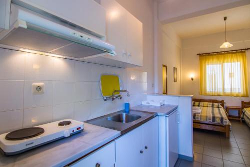 a kitchen with a sink and a counter top at Armiriki Rooms in Vrasná
