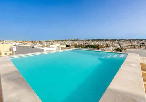 a swimming pool on the roof of a house with a view at Annitchka Mansions - Penthouse in central Malta in Birkirkara