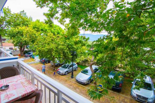 a balcony with cars parked in a parking lot at Armiriki Rooms in Vrasná