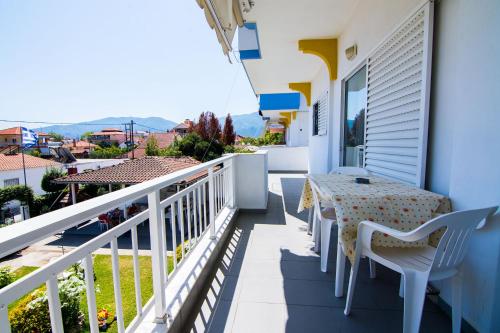 a balcony with a table and chairs and a view at Armiriki Rooms in Vrasná