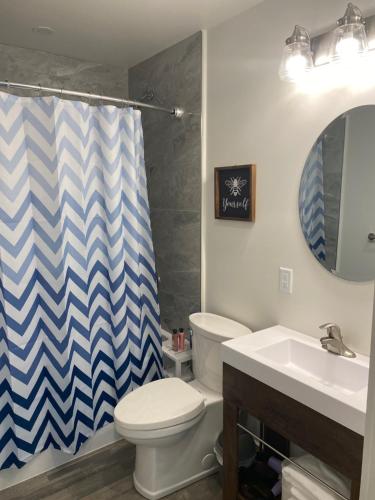 a bathroom with a toilet and a sink at The Hideaway Cottage with Private trails in Waweig