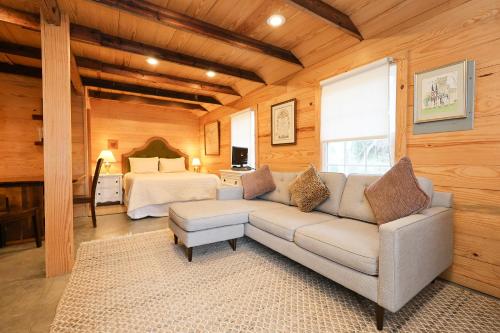 a living room with a couch and a bed at The Dailey Renewal Retreat B & B in Greensboro