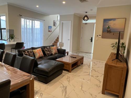 a living room with a couch and a coffee table at Modern house between Airport and Sea in Seaton