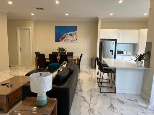 a living room with a couch and a table at Modern house between Airport and Sea in Seaton