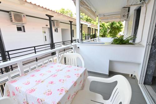 a table and two chairs on a balcony with a table and chairs at Armiriki Rooms in Vrasná