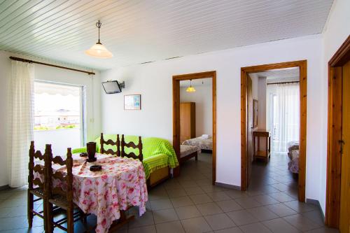 a room with a table and a bed and a bedroom at Armiriki Rooms in Vrasná