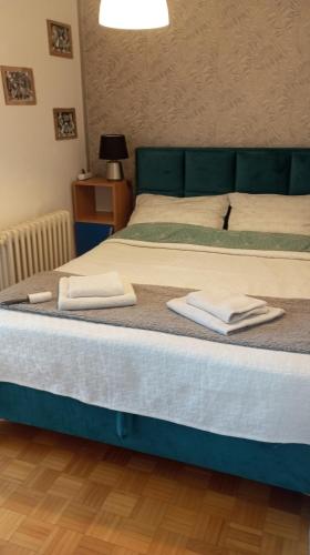 a bedroom with a bed with two towels on it at Apartment MrCvetko FREE PARKING in Bežanija