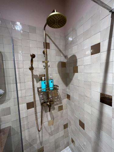 a shower with two blue candles in a bathroom at Dar Fafy studio cosy au calme à 15min de Nantes in Bouguenais