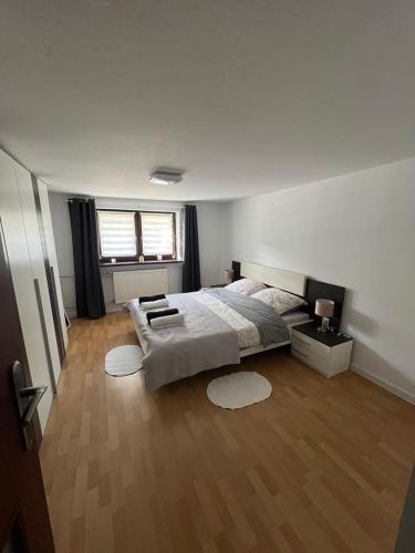 a bedroom with a large bed and a wooden floor at Apartament Koninki in Poręba Wielka