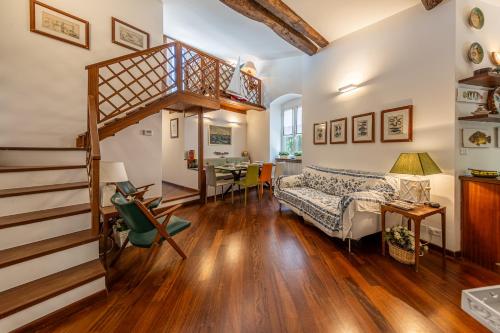 a living room with a staircase and a bed at PETITE PARAGGI Vista e Comodità sul Mare in Santa Margherita Ligure