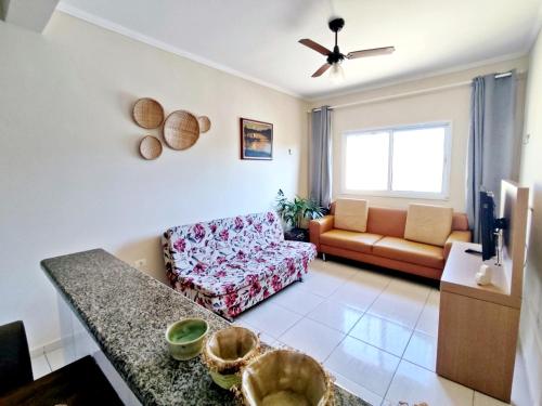 a living room with a couch and a table at Casa KAIS Peruíbe in Peruíbe