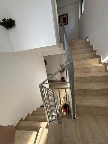 a staircase with a glass railing in a house at Alexander Residence in Brăila