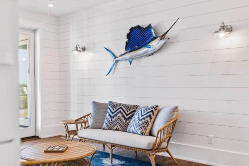 a living room with a couch and a fish on the wall at Jailbreak in Southport