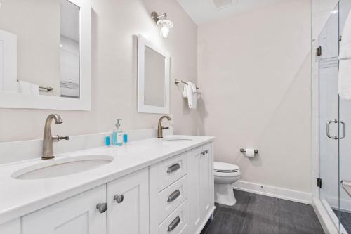 a white bathroom with a sink and a toilet at Jailbreak in Southport
