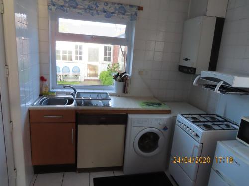 a kitchen with a sink and a washing machine at Dovehouses in Redcar