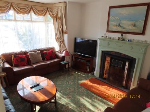 a living room with a couch and a fireplace at Dovehouses in Redcar