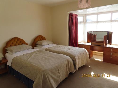 a bedroom with two beds and a window at Dovehouses in Redcar