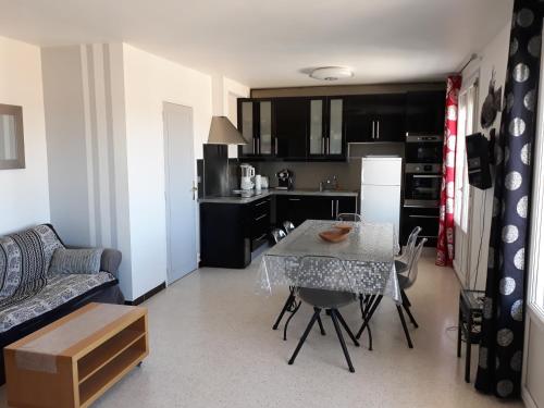 une cuisine et un salon avec une table et des chaises dans l'établissement Belle Vue, à Palavas-les-Flots