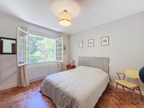 une chambre avec un lit et une grande fenêtre dans l'établissement M-Pinada 01-Moliets Maison de vacances 6 Personnes proche de la plage, à Moliets-et-Maa